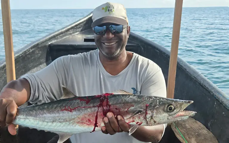 Smiling on a local boat with a big mackerel just caught
